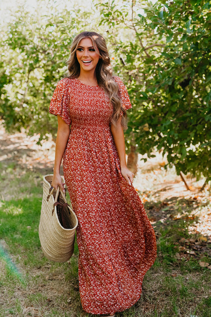 THE ESTELLE SMOCKED MAXI DRESS IN FLORAL RUST